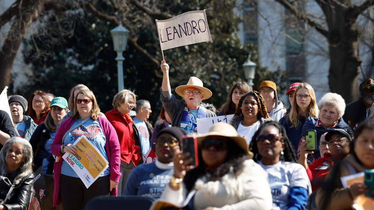 Supporters listen during a rally for education funding on the grounds of the N.C. State Capitol in Raleigh Thursday, Feb. 22, 2024. The rally happened as the state Supreme Court heard oral arguments in the long-running Leandro school funding case.
