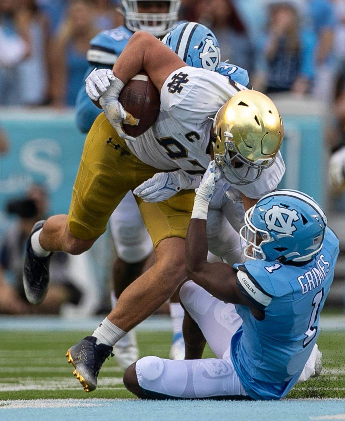 North Carolina’s Tony Grimes (1) stops Notre Dame’s Michael Mayer (87) in the second quarter on Saturday, September 24, 2022 at Kenan Stadium in Chapel Hill, N.C.