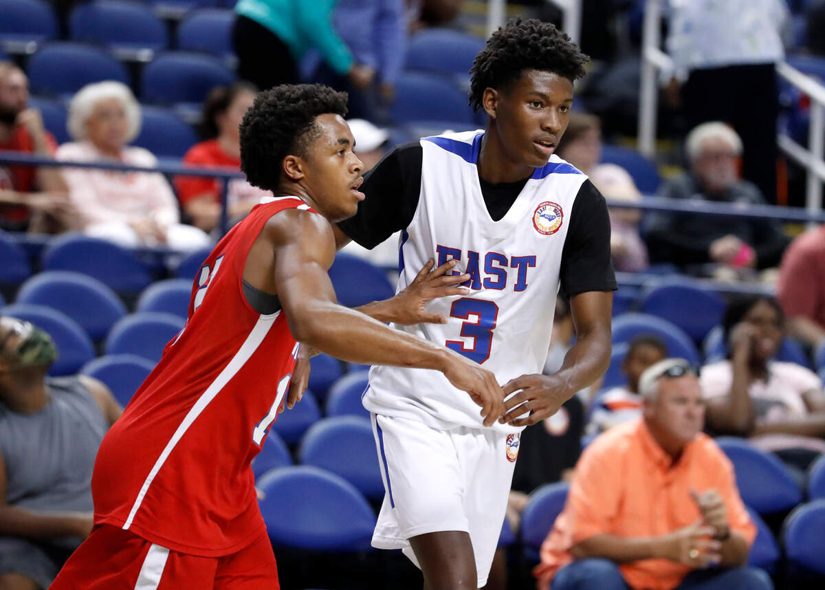 West’s Breon Pass (12) guards East’s Terquavion Smith (3) during the second half of the North Carolina High School Athletic Association men’s basketball All-Star game at Greensboro Coliseum in Greensboro, N.C., Monday, July 19, 2021.