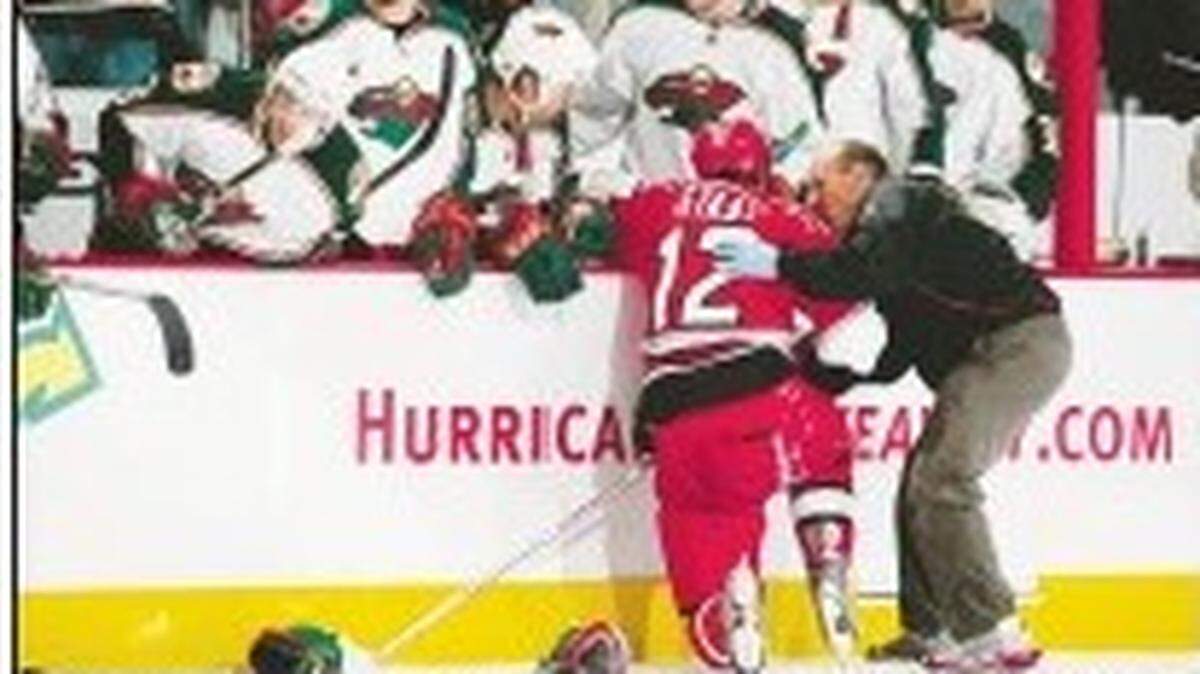 Carolina Hurricanes trainer Pete Friesen attends to Eric Staal after a hit by Minnesota Wild forward Aaron Voros in 2008.