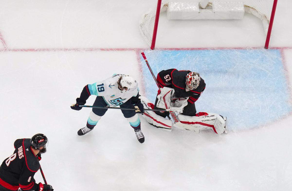 Carolina Hurricanes goaltender Pyotr Kochetkov (52) stops the shot against Seattle Kraken left wing Jared McCann (19) during the second period at Lenovo Center.