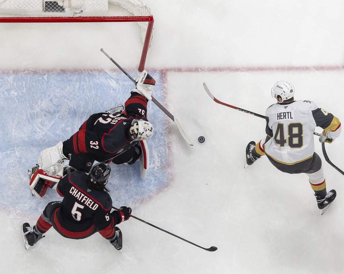 Carolina Hurricanes goalie Brandon Bussi (32) stops a scoring attempt by Vegas center Tomáš Hertl (48) during the third period, in Game 5 of the Stanley Cup Final, on Thursday, June 11, 2026 at Lenovo Center in Raleigh, N.C.