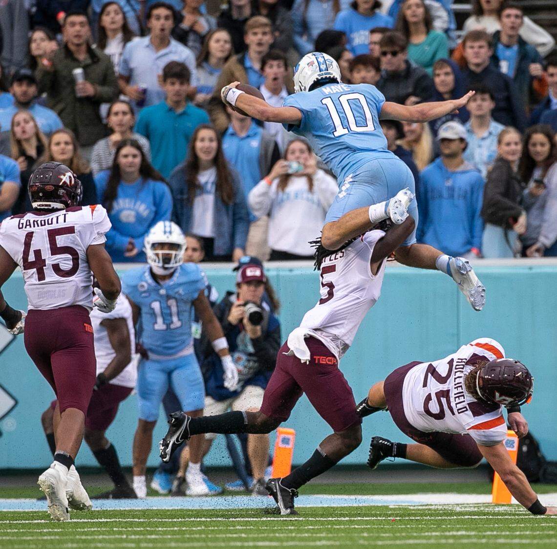 North Carolina quarterback Drake Maye (10) hurdles over Virginia Tech’s Nasir People (5) for a six-yard gain in the third quarter on Saturday, October 1, 2022 at Kenan Stadium in Chapel Hill, N.C. Maye was injured on the play.