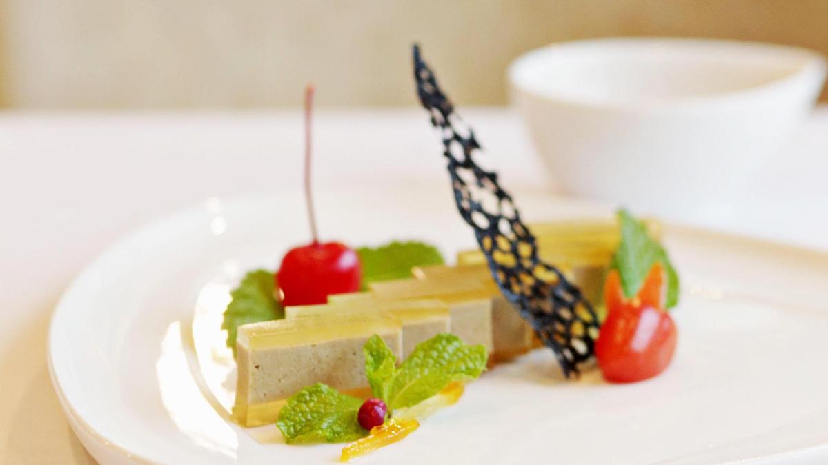 G.58 Cuisine’s foie gras mousse is made up of precisely cut blocks of silky liver, each glazed with a translucent layer of apple gelée and garnished with a lacy black rice cracker and a rivulet of sauce riddled with candied citrus peel.