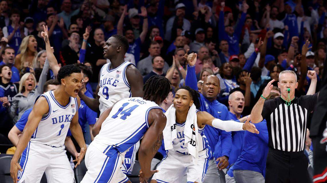 The Duke bench celebrates a basket by Sion James (14) in second half action against Louisville in the ACC Tournament championship game.