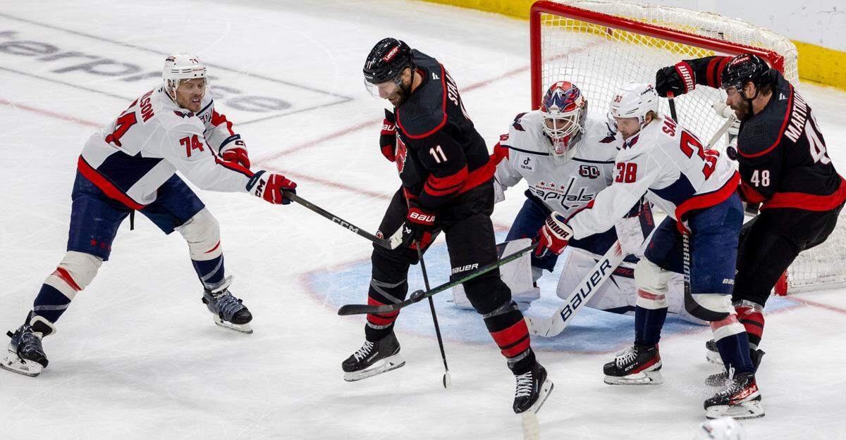 Carolina Hurricanes center Jordan Staal (11) tries to deflect the puck for a score in front of Washington Capitals goalie Logan Thompson (48) in the second period during Game 4 of their series on Monday, May 12, 2025 at Lenovo Center in Raleigh, N.C.