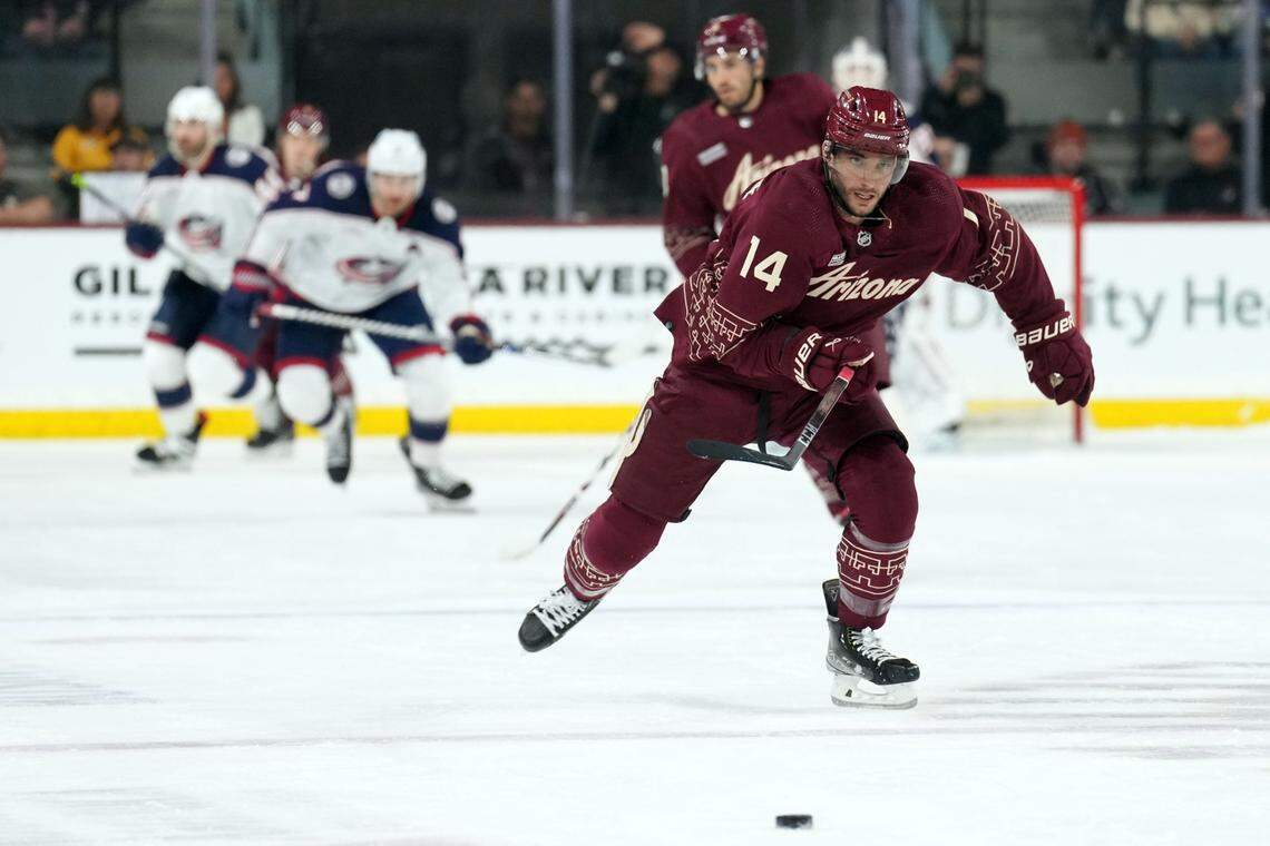 Feb 19, 2023; Tempe, Arizona, USA; Arizona Coyotes defenseman Shayne Gostisbehere (14) skates the puck against the Columbus Blue Jackets during the first period at Mullett Arena. Mandatory Credit: Joe Camporeale-USA TODAY Sports