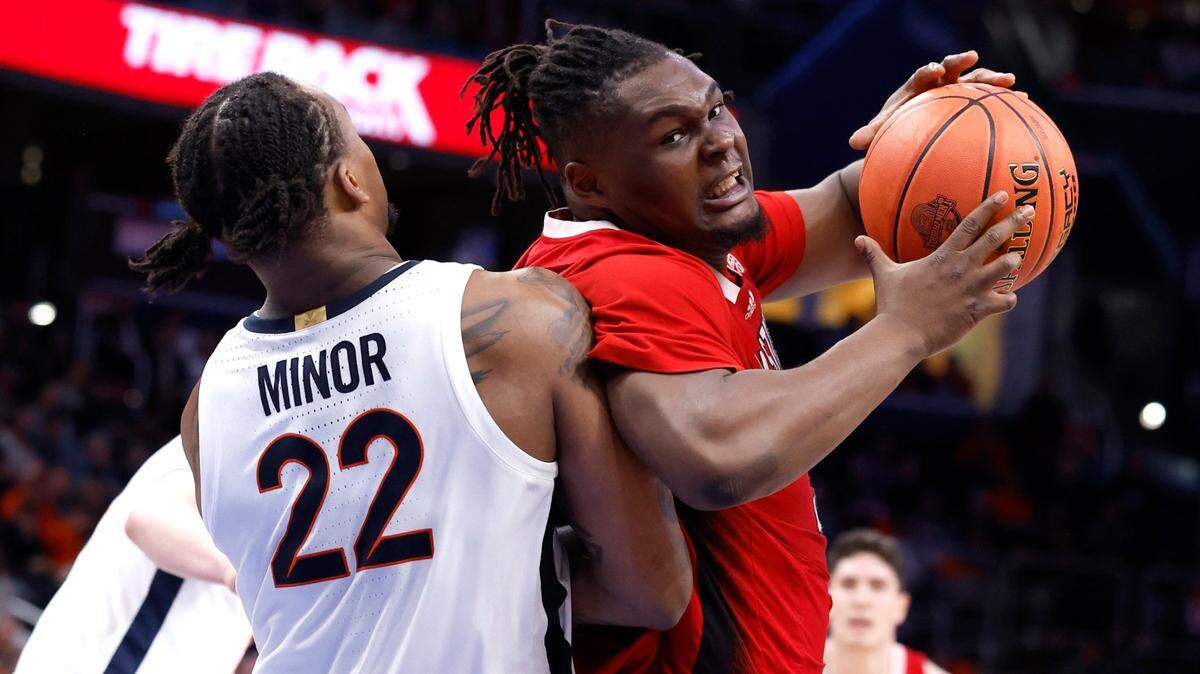 N.C. State’s DJ Burns Jr. (30) gets around Virginia’s Jordan Minor (22) during the second half of N.C. State’s 72-65 overtime victory over Virginia in the semifinals of the 2024 ACC Men’s Basketball Tournament at Capital One Arena in Washington, D.C., Friday, March 15, 2024.
