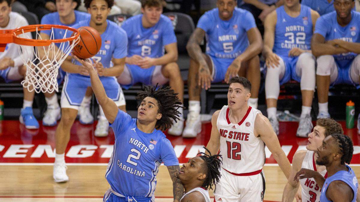 North Carolina’s Elliot Cadeau (2) drives to the basket against N.C. State’s MJ Rice (3) in the second half on Wednesday, January 10, 2024 at PNC Arena in Raleigh, N.C. Cadeau scored 11 points in the Tar Heels’ victory.
