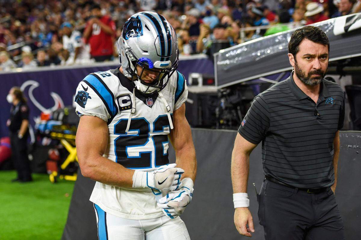 Panthers running back Christian McCaffrey, left, walks to the locker room with team athletic trainer Jean LaBaptiste after a hamstring injury during the game against the Texans at NRG Stadium on Thursday, September 23, 2021, in Houston.