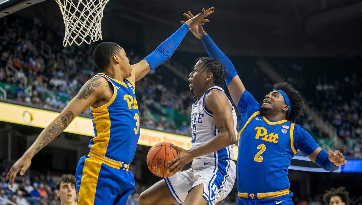 Pittsburgh’s Blake Hinson (2) and Greg Elliott (3) defend Duke’s Jeremy Roach (3) in the first half during the third round of the ACC Tournament on Thursday, March 9, 2023 at the Greensboro Coliseum in Greensboro, N.C.