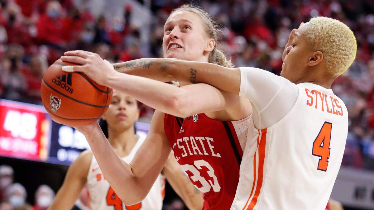 N.C. State’s Elissa Cunane (33) is fouled by Syracuse’s Alaysia Styles (4) during the second half of N.C. State’s 95-53 victory over Syracuse at Reynolds Coliseum in Raleigh, N.C., Sunday, Feb. 20, 2022.