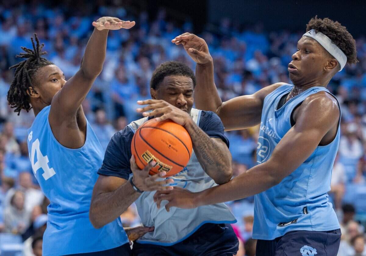 North Carolina’s Ty Claude (0) is trapped by Russell Hawkins (14) and Ven-Allen Lubin (22) in the second half during the Tar Heels’ Blue vs. White scrimmage on Saturday, October 12, 2024 at the Smith Center in Chapel Hill, N.C.