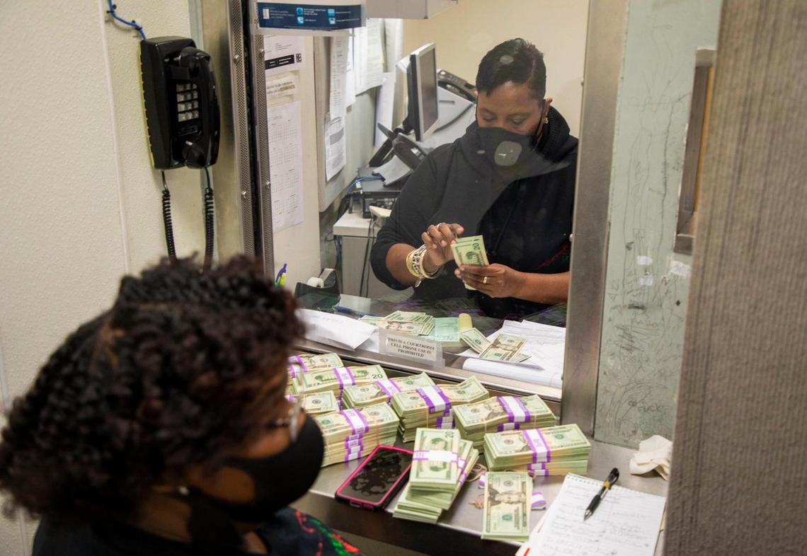 E. Evans, the Durham county chief magistrate, counts a stack of 20 dollar bills from the $100,000 in cash brought in by AndrŽa ÒMuffinÓ Hudson, director of the NC Community Bail Fund of Durham, to free 27 men as a celebration of Juneteenth and in time for them to spend FatherÕs Day at home while they await their trials, on Friday Jun. 19, 2020, at the Durham County Detention Facility, in Durham, N.C. Nineteen men were freed before the magistrate ran out of receipts around 6pm so Hudson plans to return the following day to complete the rest.