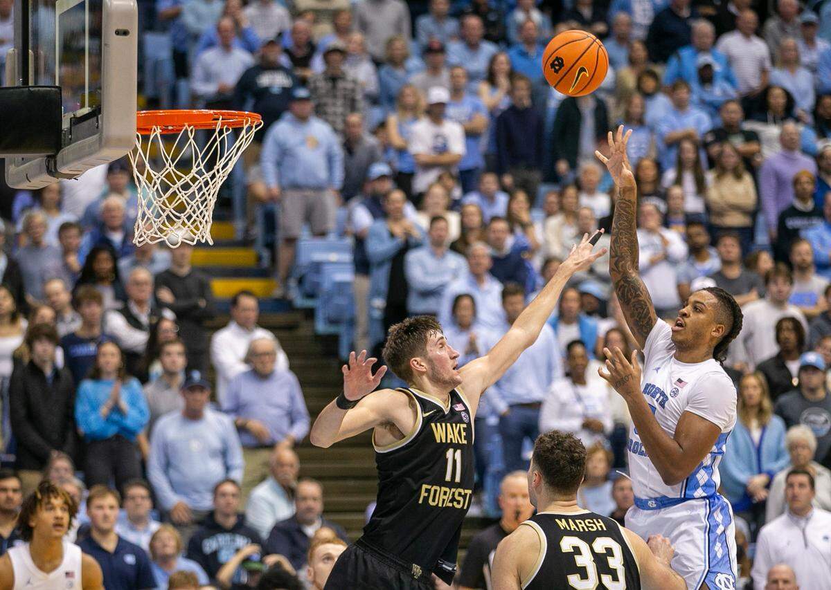 North Carolina’s Armando Bacot (5) puts up a shot against Wake Forest’s Andrew Carr (11) in the second half on Wednesday, January 4, 2023 at the Smith Center in Chapel Hill, N.C.