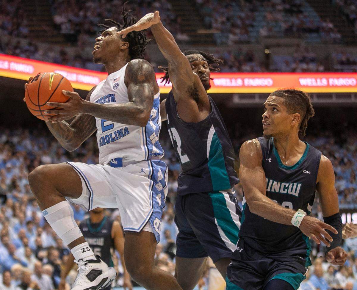 North Carolina’s Caleb Love (2) drives to the basket against UNC Wilmington’s Victor Enoh (12) in the second half on Monday, November 7, 2022 at the Smith Center in Chapel Hill, N.C. Love scored 17 points in the Tar Heels’ victory.