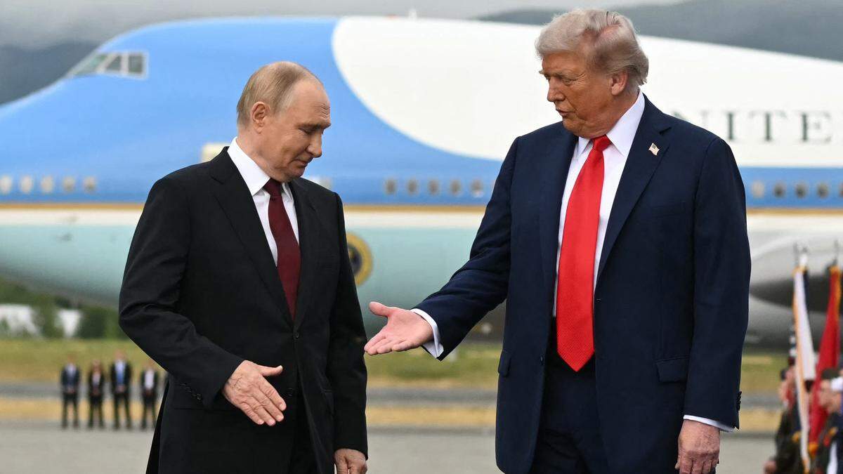 President Donald Trump reaches out to shake hands with Russian President Vladimir Putin on the tarmac after arriving at Joint Base Elmendorf–Richardson in Alaska in August.