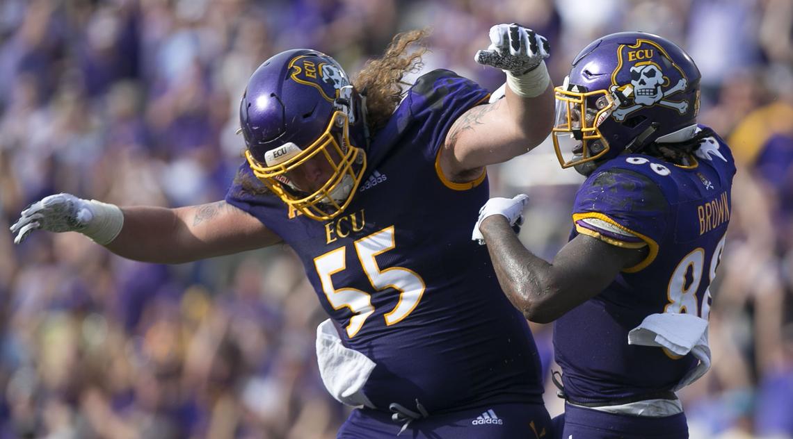 East Carolina’s Trevon Brown (88) celebrates with teammate Garrett McGhin (55) after scoring a touchdown in the second quarter against North Carolina on Saturday, September 8, 2018 at Dowdy-Ficklen Stadium in Greenville, N.C.