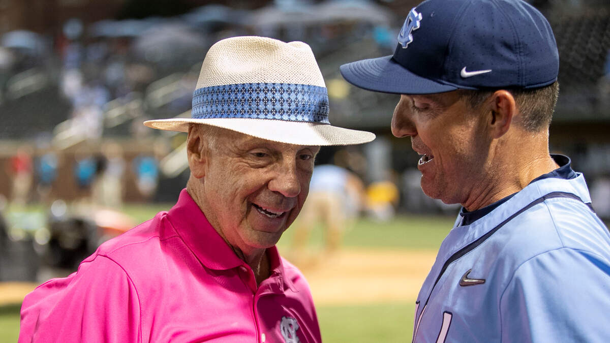 Former North Carolina basketball coach Roy Williams congratulates coach Scott Forbes following their 7-3 victory over VCU on Monday, June 6, 2022, clinching their NCAA Regional baseball championship at Boshamer Stadium in Chapel Hill, N.C.