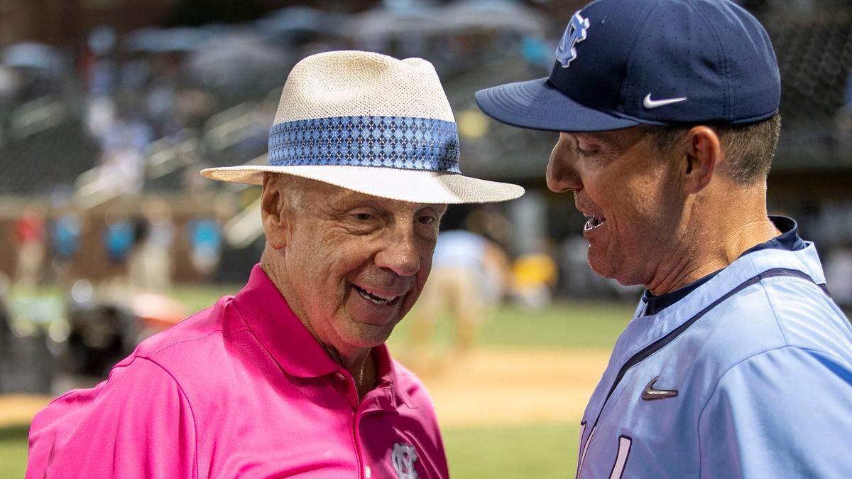 Former North Carolina basketball coach Roy Williams congratulates coach Scott Forbes following their 7-3 victory over VCU on Monday, June 6, 2022, clinching their NCAA Regional baseball championship at Boshamer Stadium in Chapel Hill, N.C.