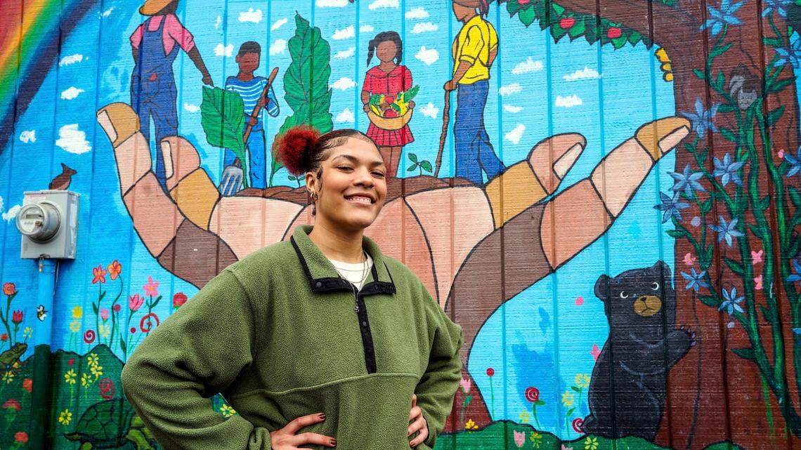 Kailani Taylor-Cribb stands in front of mural at a neighborhood community garden run by a friend of her mother, in Asheville, N.C., on Tuesday, Jan. 31, 2023. She knows, looking back, that things could have been different. While she has no regrets about leaving high school, she says she might have changed her mind if someone at school had shown more interest and personal attention to her needs. “All they had to do was take action,” she said. “There were so many times they could have done something. And they did nothing.”