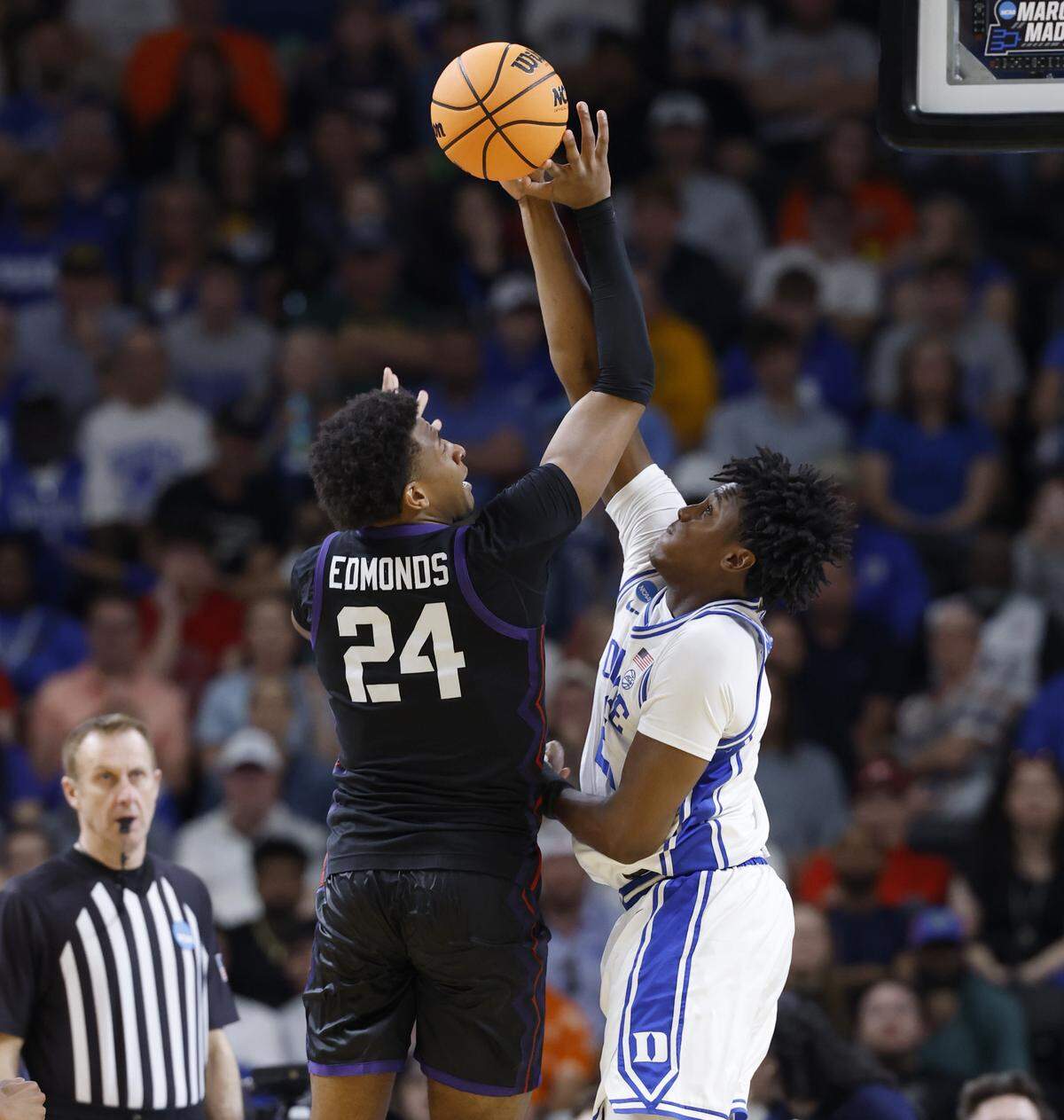 Duke’s Patrick Ngongba II (21) blocks the shot by TCU’s Xavier Edmonds (24) during the second half of Duke’s 81-58 victory over TCU in the second round of the NCAA Men’s Basketball Tournament at  Bon Secours Wellness Arena in Greenville, S.C., Saturday, March 21, 2026.