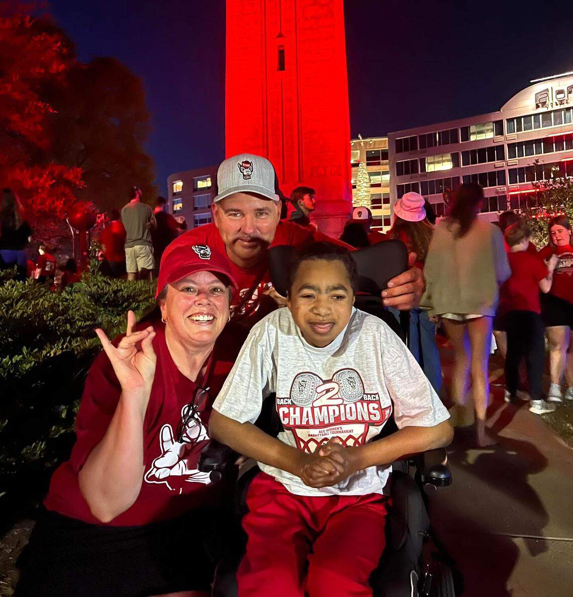 Dianne and Tim Ketchie pose with their son, Grayson, at the Belltower after N.C. State basketball defeated Duke to advance to the Final Four on March 31, 2024.