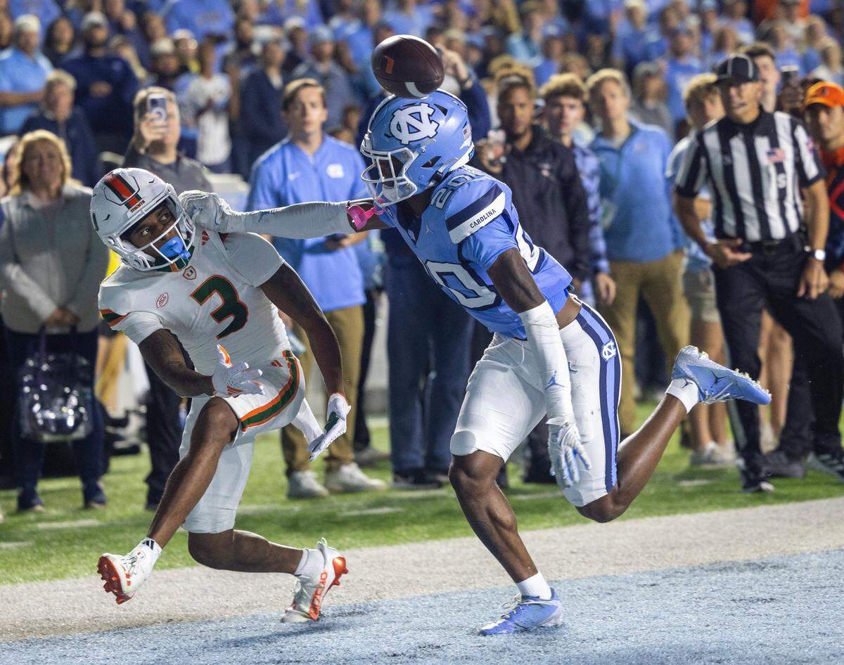 North Carolina’s Tayon Holloway (20) defends Miami wide receive Jacoby George (3) in the end zone at the end of the second quarter, holding Miami to a field goal on Saturday, October 14, 2023 at Kenan Stadium in Chapel Hill, N.C.