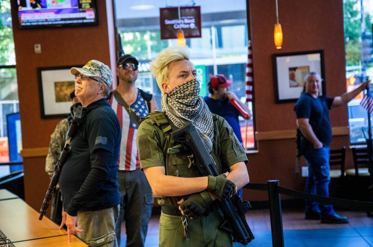 A group of about 11 mostly armed demonstrators protesting the stay-at-home order marched around downtown Raleigh and ordered sandwiches at a Subway, Saturday, May 9, 2020.