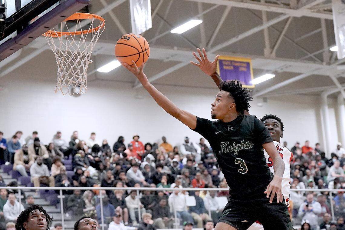Greenfield's Kobe Edwards (3) stretches for the layup past Coronado's Siyahe Siaisiai (35) during the second half. The Greenfield Knights and the Coronado Cougars (Nevada) met in the finals of the Day'Ron Sharpe bracket of the  John Wall Holiday Tournament in Raleigh, N.C. on December 30, 2025.