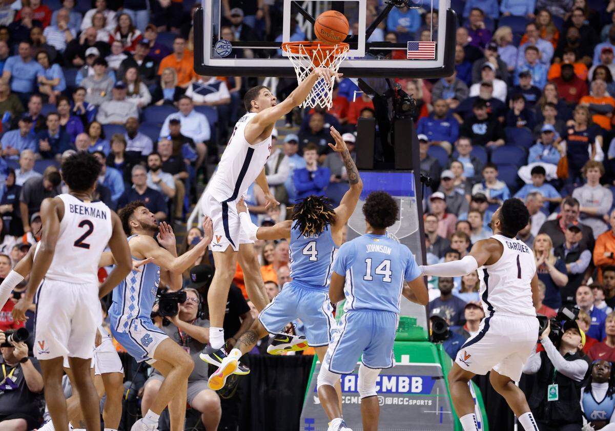 Virginia’s Kadin Shedrick (21) blocks the shot by North Carolina’s RJ Davis (4) late in the second half of Virginia’s 68-59 victory over UNC in the quarterfinals of the ACC Men’s Basketball Tournament in Greensboro, N.C., Thursday, March 9, 2023.