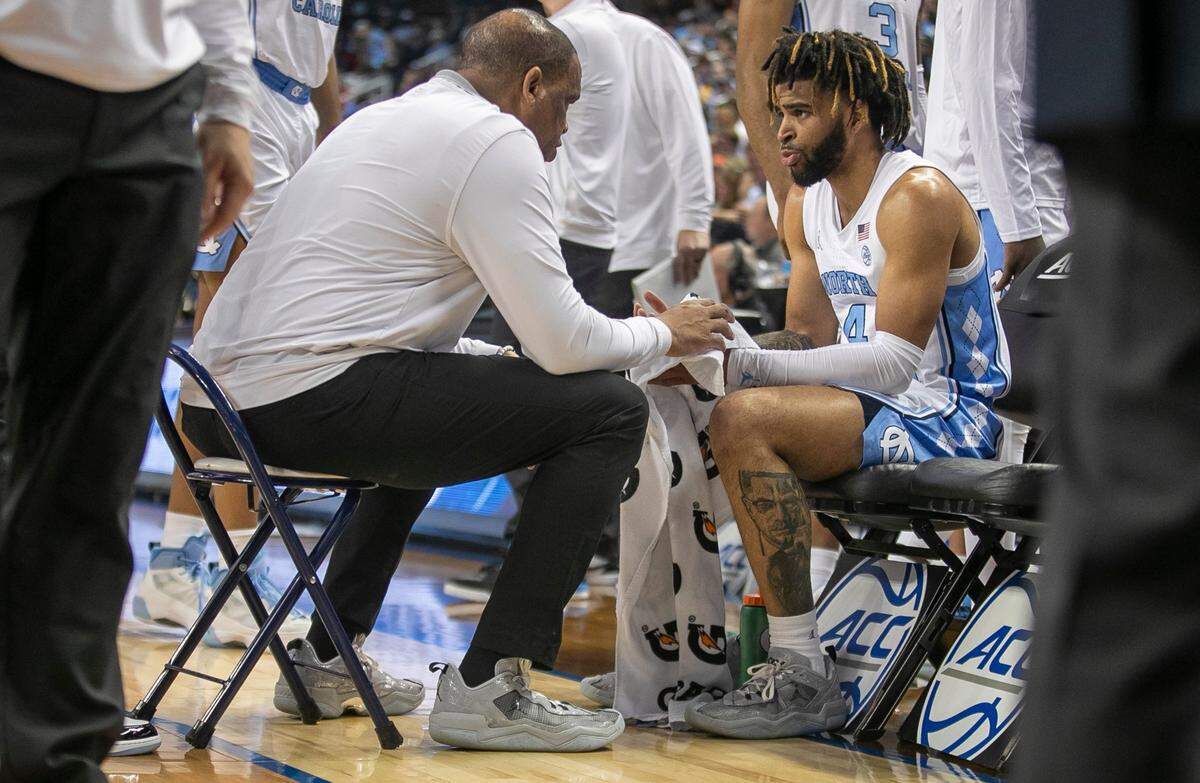 North Carolina coach Hubert Davis and R.J. Davis (4) are the last to leave the huddle after a time out in the second half against Boston College in the second round of the ACC Tournament on Wednesday, March 8, 2023 at the Greensboro Coliseum in Greensboro, N.C.