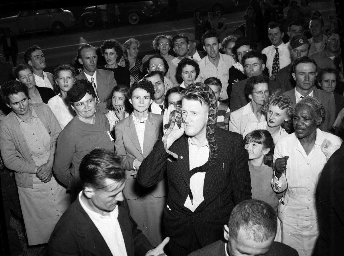 Rev. Colonel Hartman Bunn, of the Zion Tabernacle Church in Durham, N.C. in 1949 (in the dark suit with the rattle snake draped over his head).