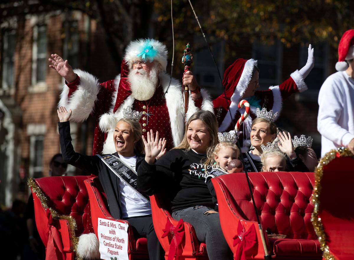 Santa waves from a carriage pulled by horses at the conclusion of the Raleigh Christmas Parade on Saturday, Nov. 18, 2023.