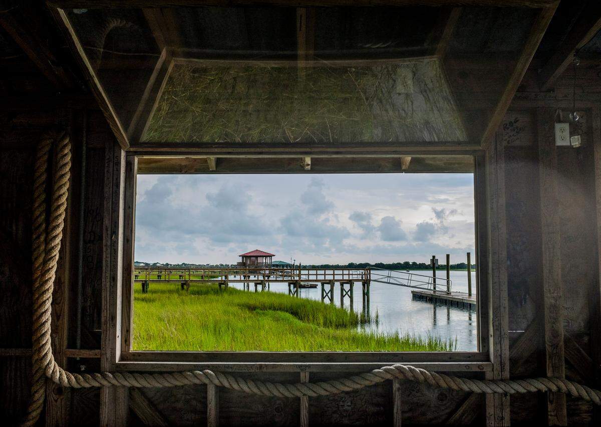 Open windows in the dock house at Bowen’s Island look out on the Folly River in Charleston County. Some scientists studying salt marshes and the shellfish that live there were told Feb. 27, 2025 that they had lost their jobs at the National Oceanic and Atmospheric Administration in Charleston. The layoffs were part of a purge of federal workers by President Donald Trump.