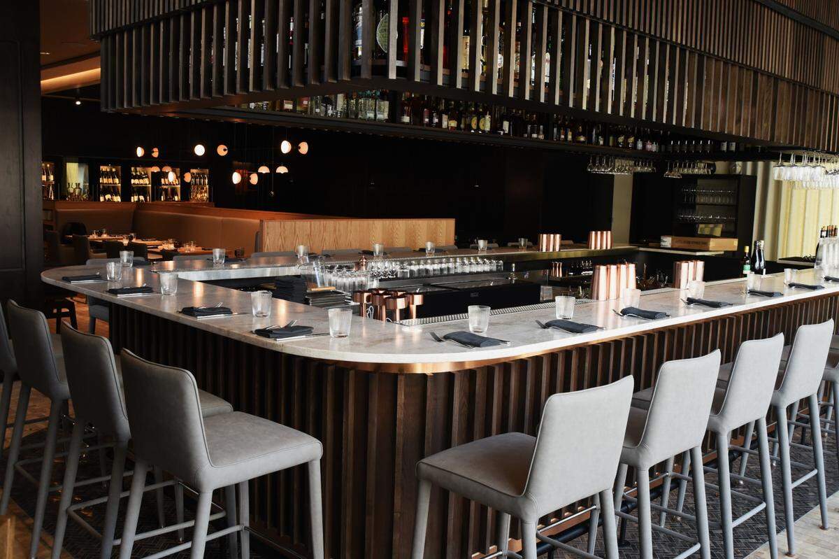 Diners can reserve every seat in Crawford Brothers Steakhouse, including the bar stools.