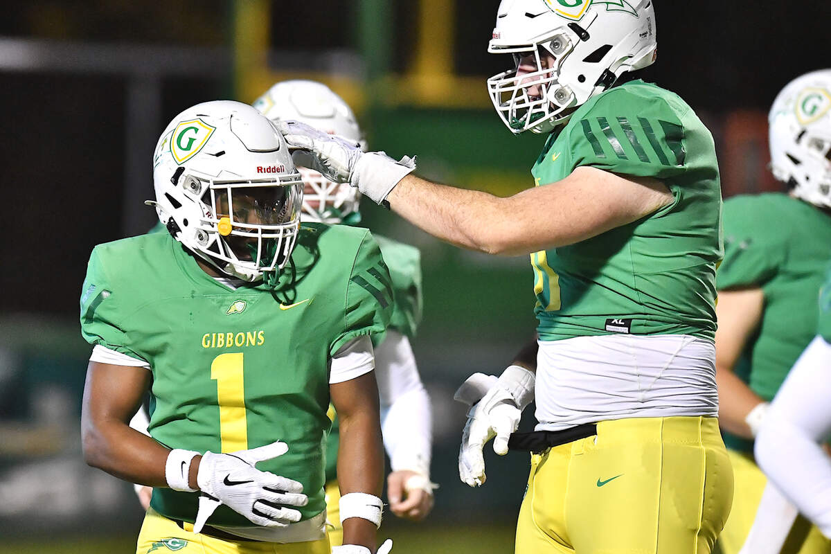 Cardinal Gibbons’ Jack Sheehan (71) congratulates Corban McDaniel (1) after making the interception and touchdown against Hillside during the first half. The Cardinal Gibbons Crusaders and the Durham Hillside Hornets met in the third round of the NCHSAA 4A playoffs in Raleigh, N.C. on November 29, 2024.
