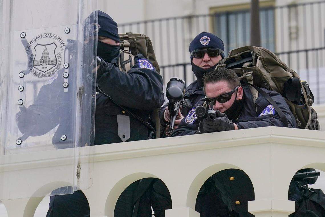 Police keep a watch on demonstrators who tried to break through a police barrier, Wednesday, Jan. 6, 2021, at the Capitol in Washington. As Congress prepares to affirm President-elect Joe Biden’s victory, thousands of people have gathered to show their support for President Donald Trump and his claims of election fraud.