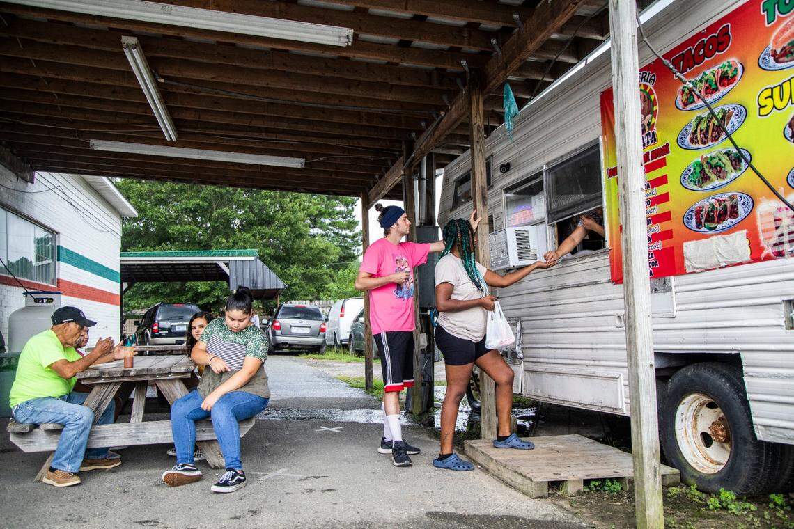 Patrons order tacos at a food truck in the unincorporated community of Dudley, NC on Monday August 10, 2020. The majority minority 28333 zip code, which includes Dudley, has a coronavirus infection rate higher than the Wayne county average and has one of the largest changes in infection rates during the period from May 22 to July 13.