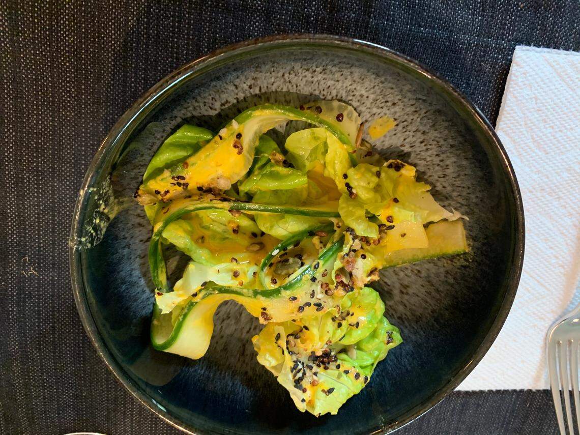 A delicate salad of butter crunch lettuce and ribbons of cucumber with a miso-ginger dressing and black sesame seeds survived a car trip from Crawford and Son in Raleigh.