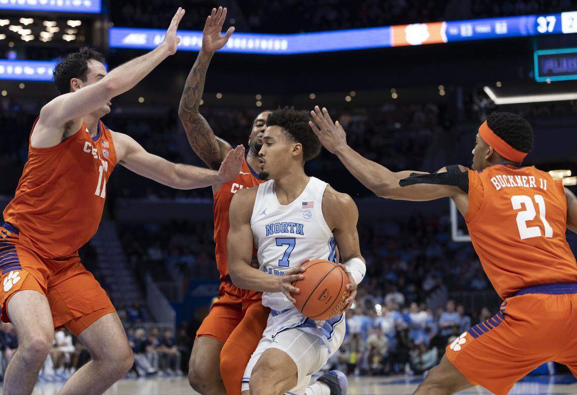 Clemson forward Nick Davidson (11), guards Dillon Hunter (2) and Ace Buckner (21) collapse around North Carolina guard Seth Trimble (7) in the first half on Thursday, March 12, 2026, during the quarterfinals of the ACC Tournament at Spectrum Center in Charlotte, N.C.