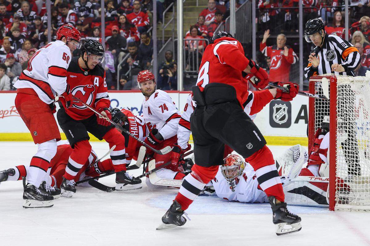 Apr 25, 2025; Newark, New Jersey, USA; Carolina Hurricanes goaltender Frederik Andersen (31) makes a glove save on New Jersey Devils right wing Timo Meier (28) during the second period in game three of the first round of the 2025 Stanley Cup Playoffs at Prudential Center. Mandatory Credit: Ed Mulholland-Imagn Images
