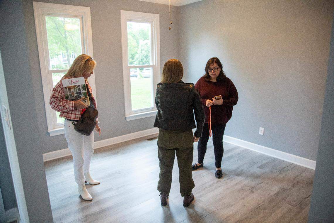 First-time home buyers Carolina Acuipil, right, and Carolina Rancano, center, tour a home for sale with Real Estate Broker Colleen Blondell in Cary on Thursday, April 27, 2023.