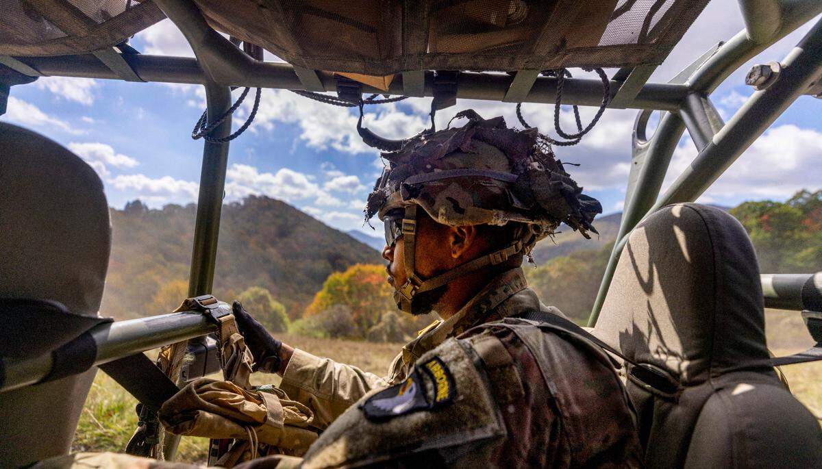 A soldier with the 101st Airborne Division Air Assault, 2nd Brigade Combat Team, from Fort Campbell, Kentucky, rides in an Infantry Squad Vehicles while delivering water, food, toiletries, and other aid to residents in the Soco Gap community in Maggie Valley on Tuesday, October. 8, 2024. The team has been using the Maggie Valley Pavilion and Town Hall as a distribution base for relief efforts in the town following Tropical Storm Helene.
