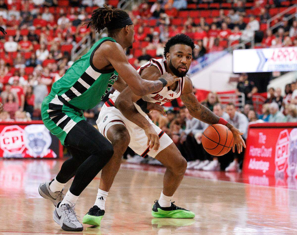 N.C. State’s Dontrez Styles handles the ball against USC Upstate’s Mister Dean during the second half of the Wolfpack’s 97-66 win on Monday, Nov. 4, 2024, at Lenovo Center in Raleigh, N.C.