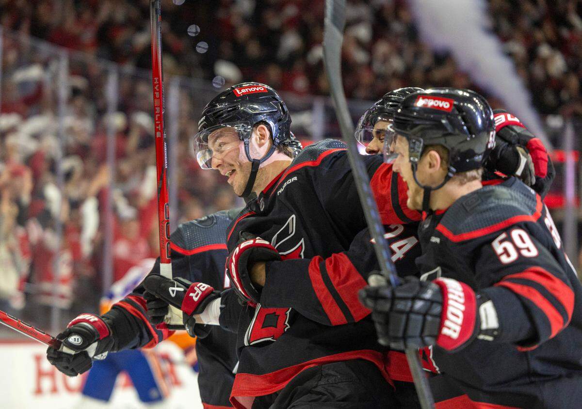 Carolina Hurricanes left wing Andrei Svechnikov (37) is surrounded by teammates after scoring against New York Islander goalie Semyon Varlamov (40) in the first period during Game 5 of the NHL Eastern Conference quarterfinals agains the New York Islanders on Tuesday, April 30, 2024 at PNC Arena, in Raleigh N.C.