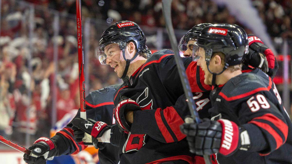 Carolina Hurricanes left wing Andrei Svechnikov (37) is surrounded by teammates after scoring against New York Islander goalie Semyon Varlamov (40) in the first period during Game 5 of the NHL Eastern Conference quarterfinals agains the New York Islanders on Tuesday, April 30, 2024 at PNC Arena, in Raleigh N.C.