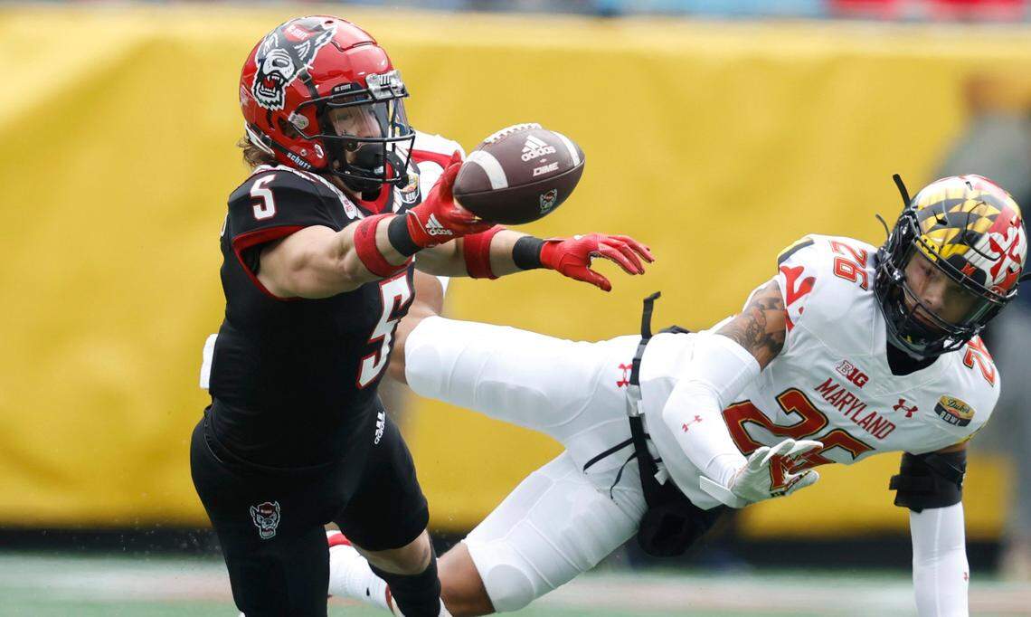 N.C. State wide receiver Thayer Thomas (5) can’t pull in the reception as Maryland defensive back Gavin Gibson (26) defends during the first half of N.C. State’s game against Maryland in the Duke’s Mayo Bowl at Bank of America Stadium in Charlotte, N.C., Friday, Dec. 30, 2022.