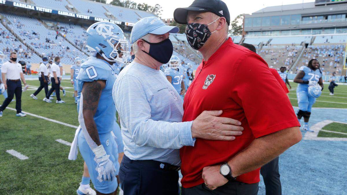 North Carolina head coach Mack Brown talks with N.C. State head coach Dave Doeren after UNCs 48-21 victory over N.C. State at Kenan Stadium in Chapel Hill, N.C., Saturday, Oct. 24, 2020.