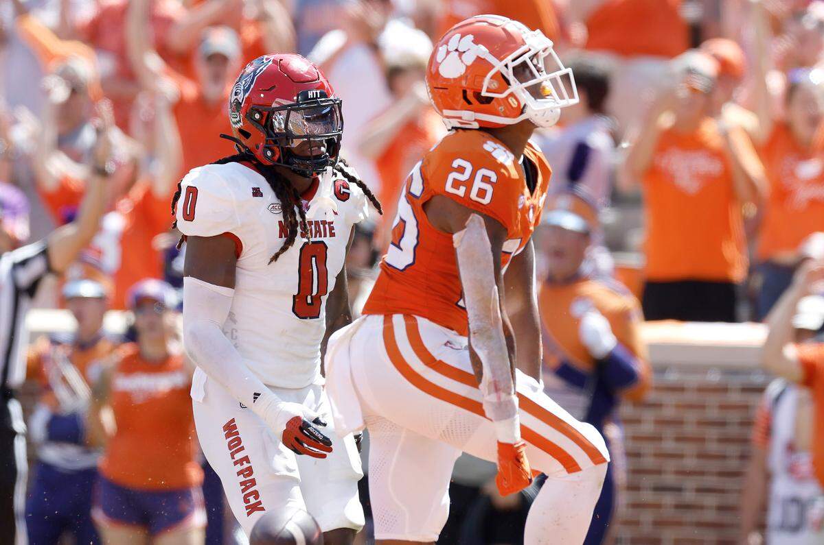 Clemson running back Jay Haynes (26) celebrates scoring on a 19-yard touchdown run as N.C. State linebacker Sean Brown (0) looks on during the first half of N.C. State’s game against Clemson at Memorial Stadium in Clemson, S.C., Saturday, Sept. 21, 2024.